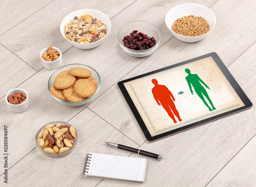 Arrangement of healthy Ingredients with a tablet. Dieting concept Arrangement of healthy Ingredients with a tablet. Dieting concept
