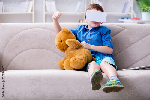 Young little boy with VR virtual reality glasses photo