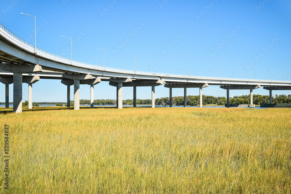 Long concrete bridge foundation crossing marsh area Long concrete bridge foundation crossing marsh area