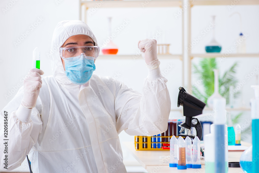 Young chemist student working in lab on chemicals Young chemist student working in lab on chemicals