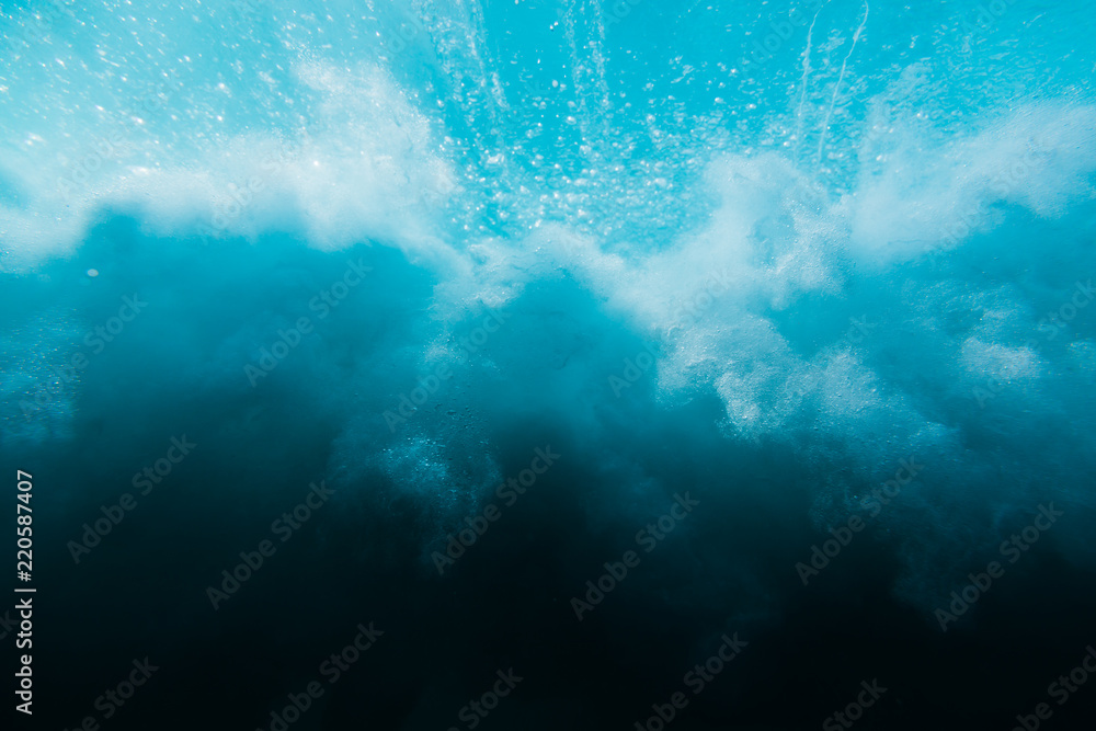Wave in underwater. Wave crashing on beach, clouds of water Wave in underwater. Wave crashing on beach, clouds of water