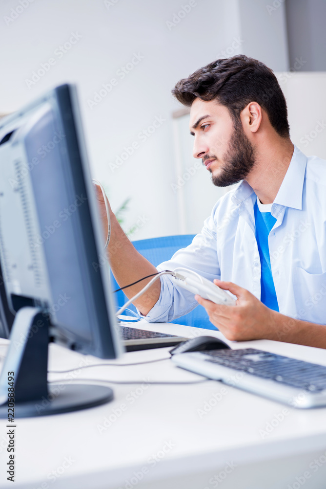 Fototapeta premium IT technician looking at IT equipment