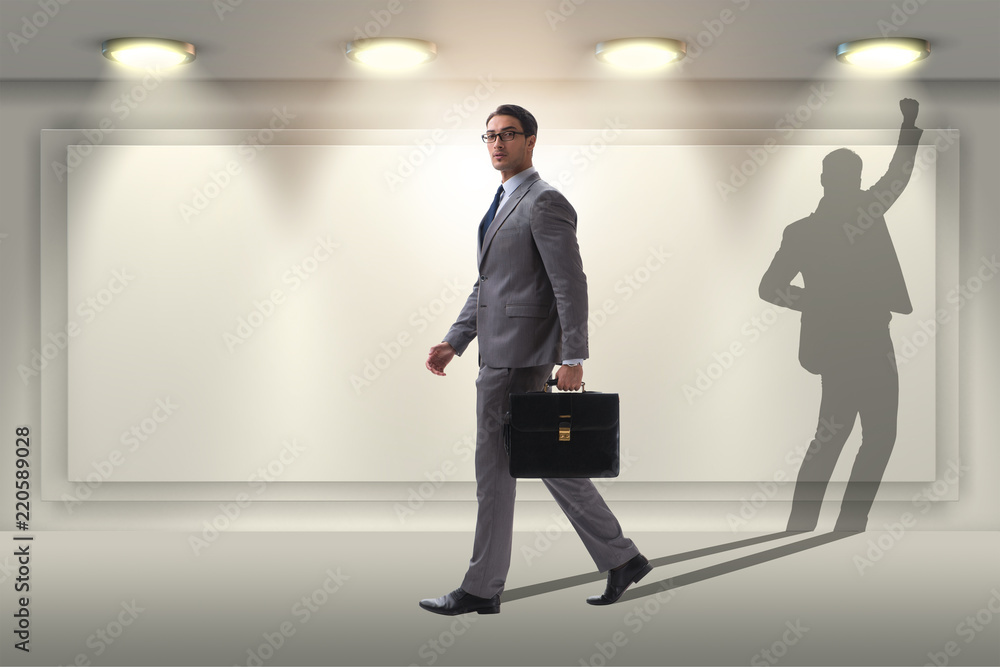 Businessman and his shadow in business concept Businessman and his shadow in business concept