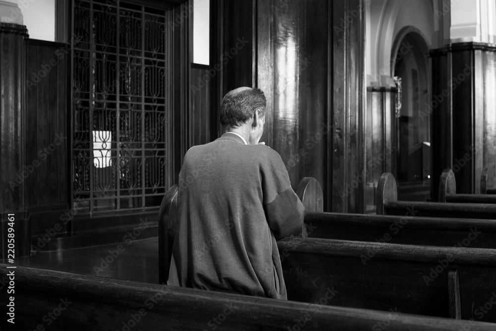 Back View Of An Old Man Praying In The Church