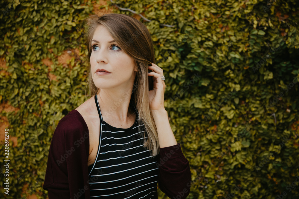 Cute Attractive Blonde Young Woman in Stripes Smiling and Posing for Camera Downtown Cute Attractive Blonde Young Woman in Stripes Smiling and Posing for Camera Downtown