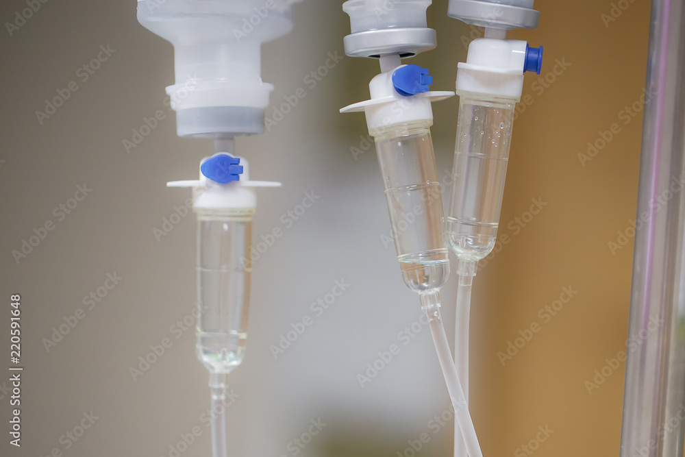 Close up saline bottle and saline drop with blur background. Illness treatment. Health insurance plan. Medical Benefits. Reimbursement. Medical expenses. image for illustration, copy space, article. Close up saline bottle and saline drop with blur background. Illness treatment. Health insurance plan. Medical Benefits. Reimbursement. Medical expenses. image for illustration, copy space, article.