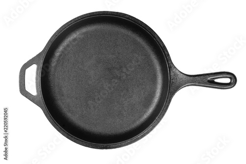 Empty, clean black cast iron pan or dutch oven top view from above over white