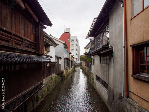 Wide detail of multiple concrete buildings and traditional wooden houses along the canals of Kurokabe residential district. Nagahama, Shiga, Japan. Travel and architecture