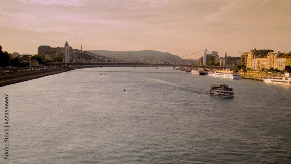 Ferry in Danube River with Chain Bridge behind it Ferry in Danube River with Chain Bridge behind it