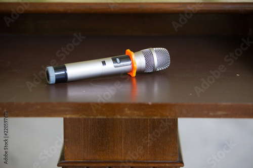 microphone placed on the podium in conference room with blur people guest background. image for background.equipment for lecturer, moderator of conference hall or seminar room background.