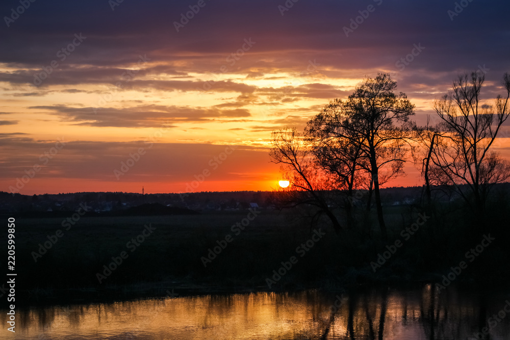 Beautiful sunset over the river in spring in May
