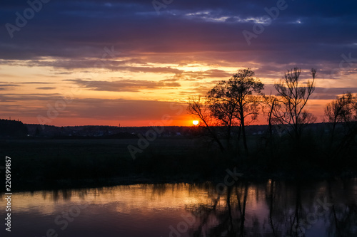 Beautiful sunset over the river in spring in May 