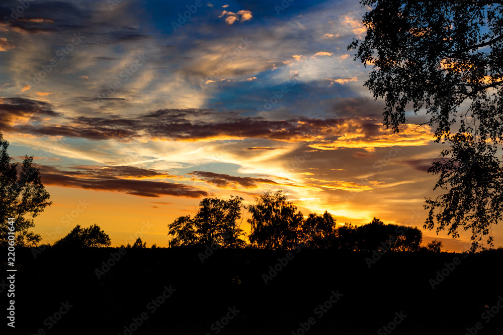 Bright beautiful sunset with clouds in summer