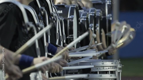 Marching band drummers with drumsticks in slow motion