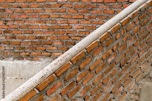 Red brick building structure is fragile. Horizontal Wide Brickwall Background.