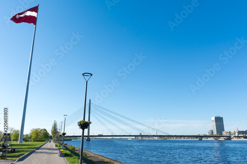 A view of the Daugava river and vansu bridge, Latvia flagpole with flag © KVN1777