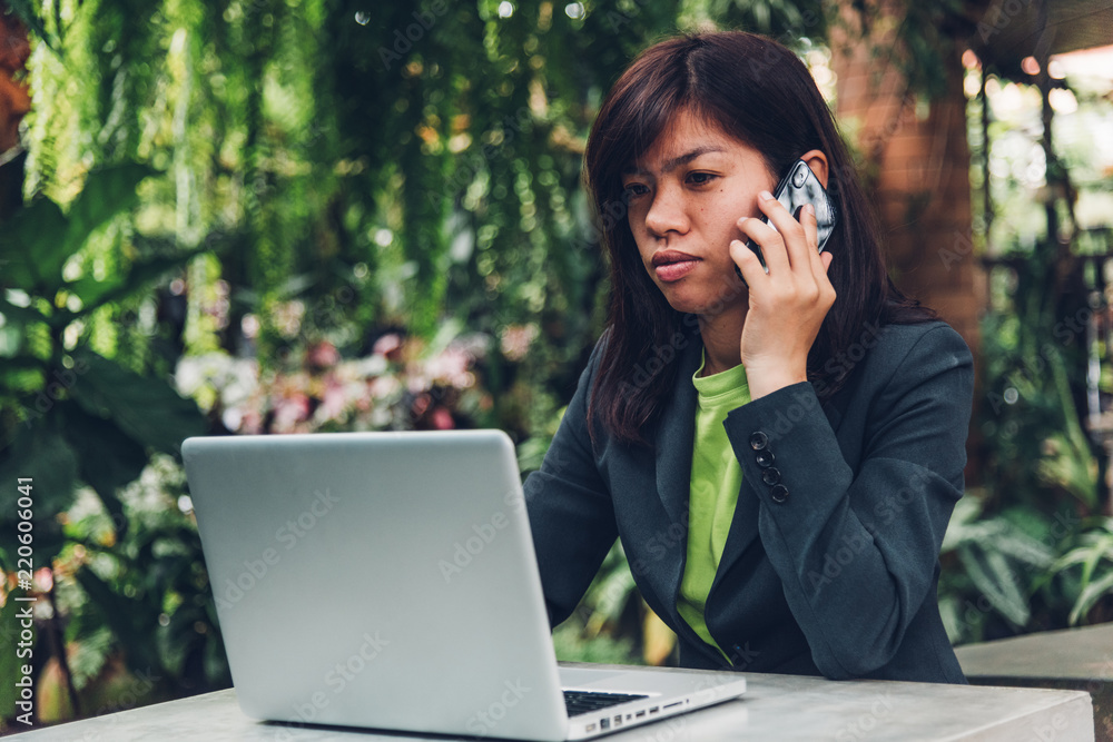 Young businesswoman talking on mobile smart phone with his client. Young businesswoman talking on mobile smart phone with his client.