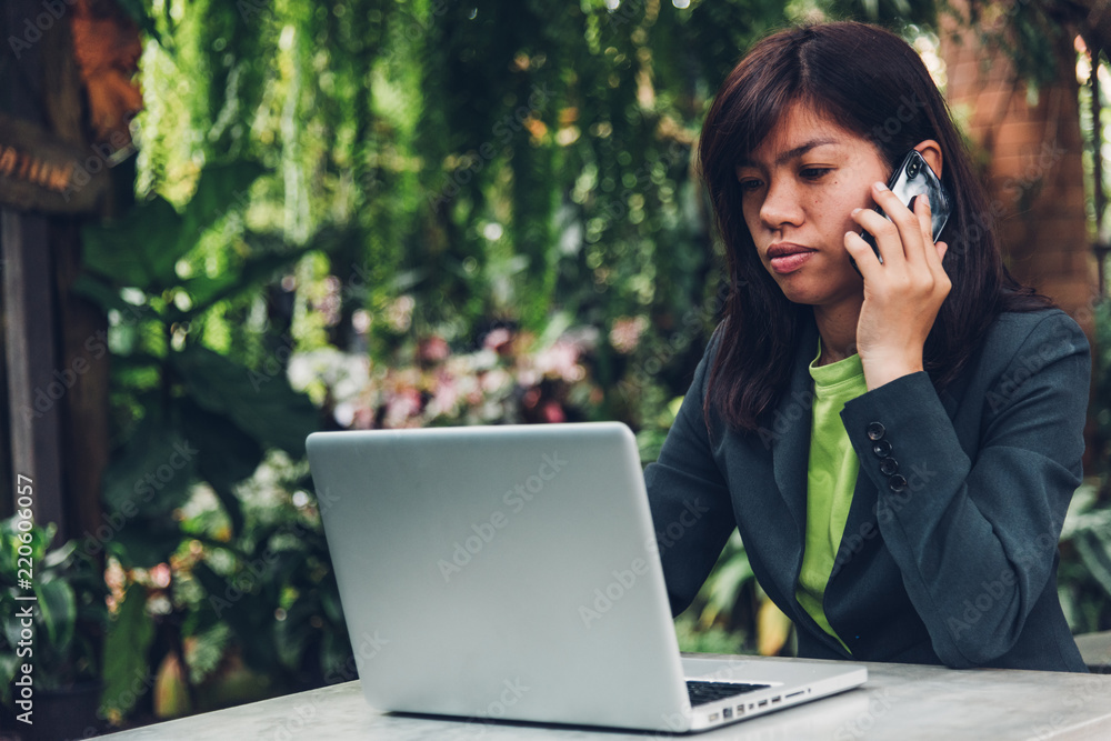 Young businesswoman talking on mobile smart phone with his client. Young businesswoman talking on mobile smart phone with his client.