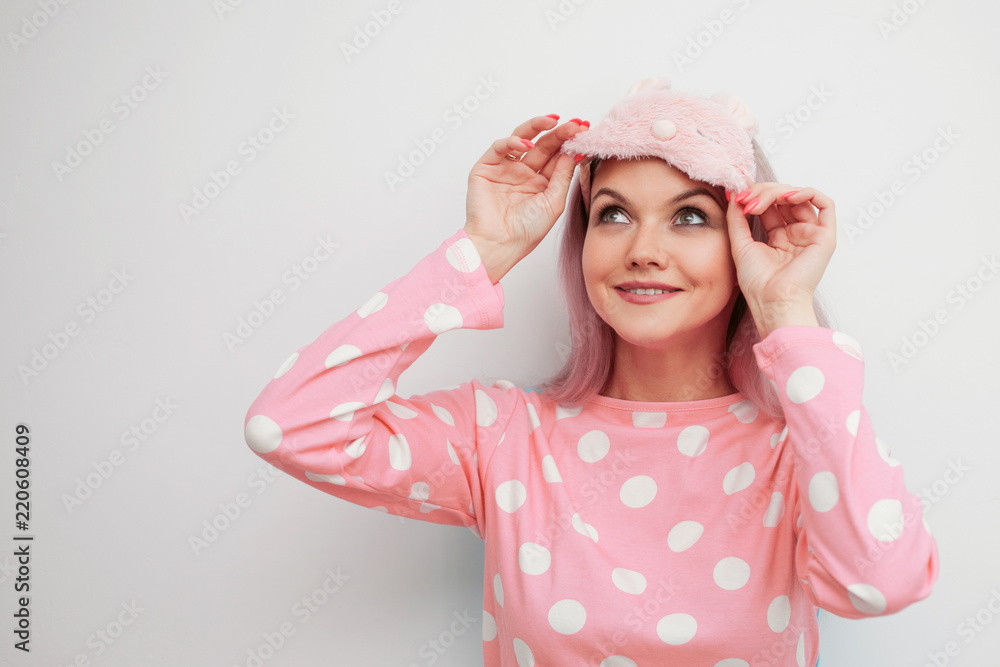 Beautiful young blonde in pink pajamas and a sleep mask Beautiful young blonde in pink pajamas and a sleep mask