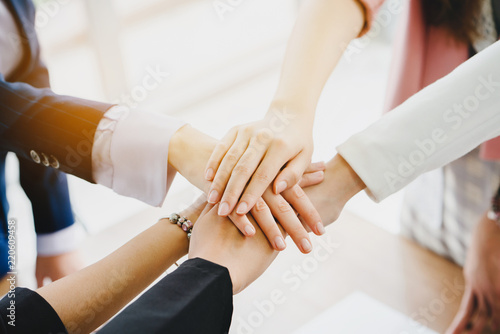 Many business people join hands to demonstrate harmony. The determination to work successfully achieved the goal. Work together. Teamwork requires clear division of work to achieve the goal. photo