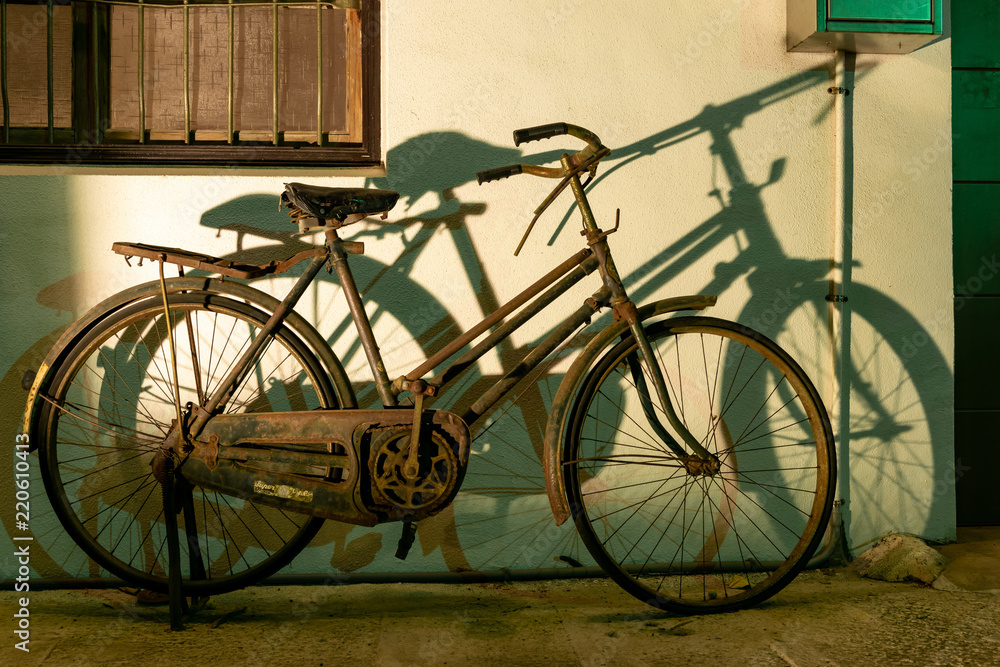 Taichung, Taiwan. 31-May-2018. Old rusted bicycle and its shadow against a wall