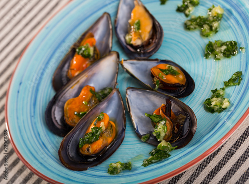 Steamed mussels on blue plate