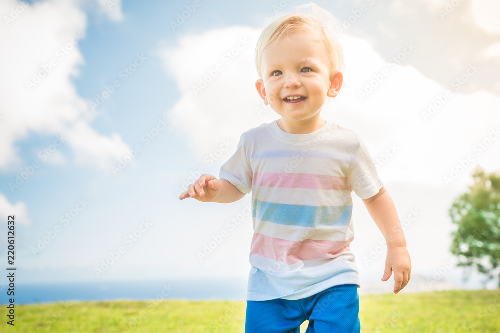Cute happy little boy running with big smile. Cute happy little boy running with big smile.