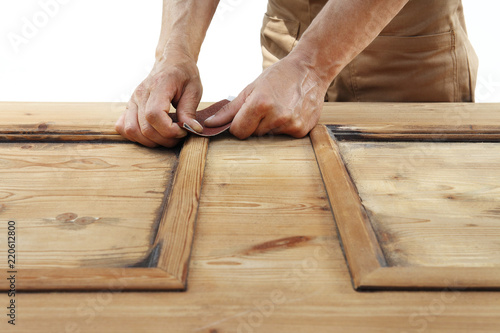 carpenterr hands work the wood with sandpaper