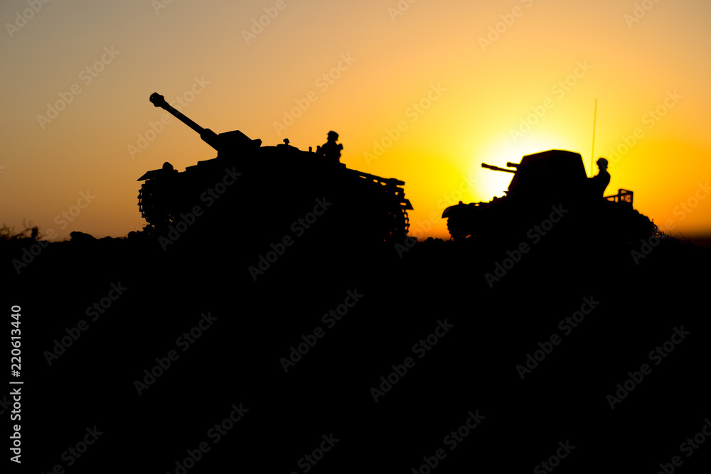 War Concept. Military silhouettes fighting scene. World War German Tanks and soldiers silhouettes at sunset. Attack scene. Armored vehicles.