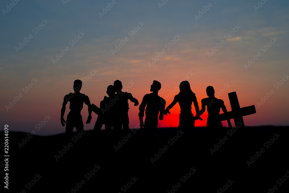 Fototapeta premium Silhouette some zombies on the cemetery walking around at sunset