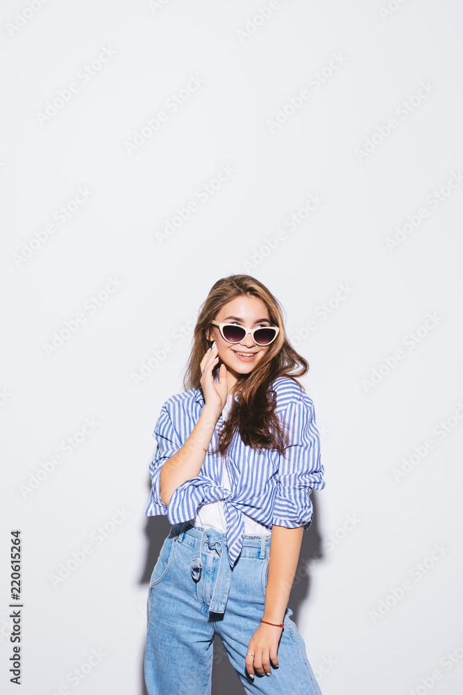 Pretty young sexy fashion sensual woman posing on white wall background Pretty young sexy fashion sensual woman posing on white wall background