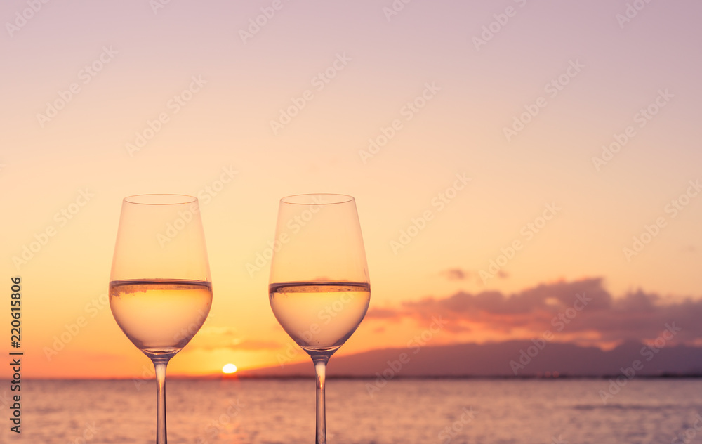 Pair of wine glasses, and romantic sunset view. 