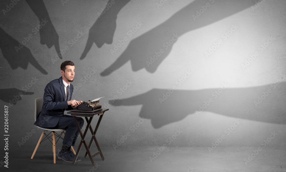 Shadow hand pointing at a small afraid worker
Shadow hand pointing at a small afraid worker