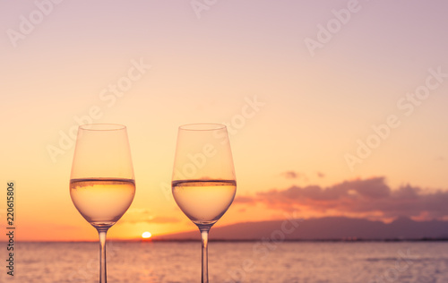 Pair of wine glasses, and romantic sunset view. 