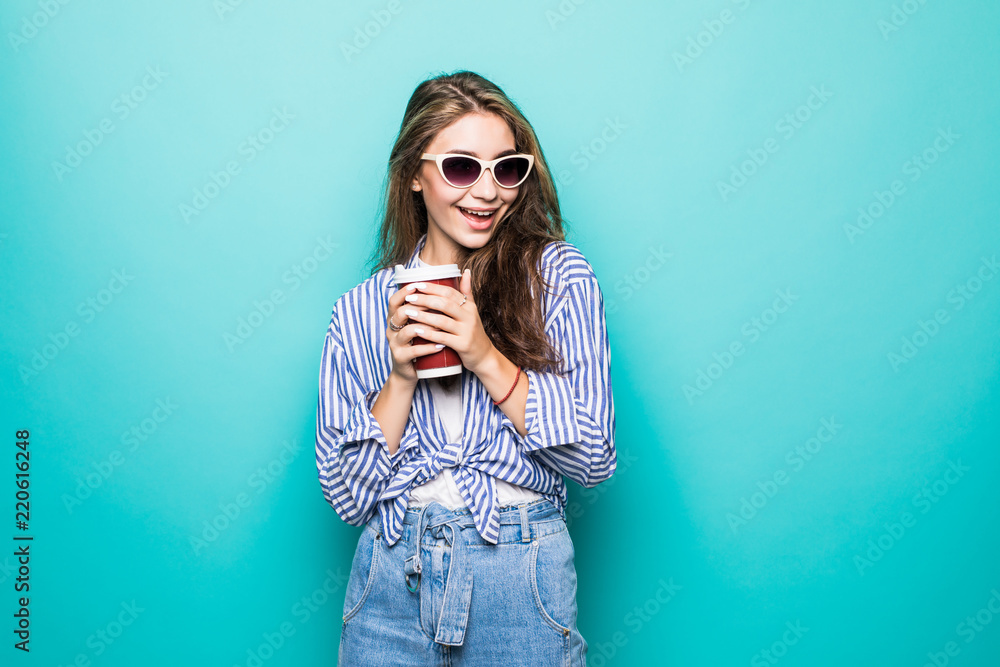Fashion pretty woman with coffee cup over colorful blue background