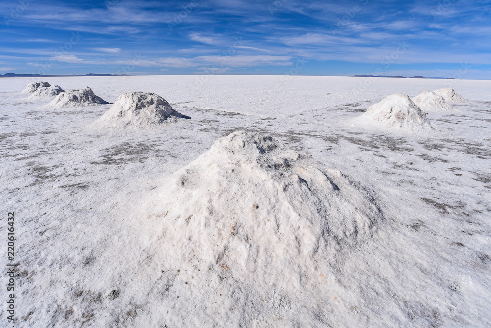 Piles of salt drying in the sun near the mining town of Colcani. Salar