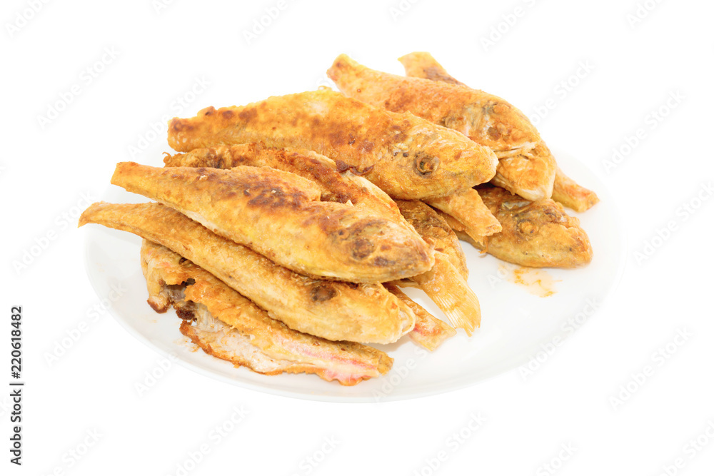 Dish of fried fishes red mullets isolated on white background Dish of fried fishes red mullets isolated on white background