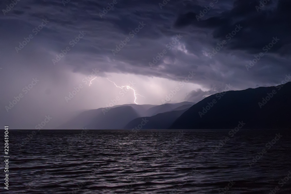 lightning storm clouds lake mountains sky