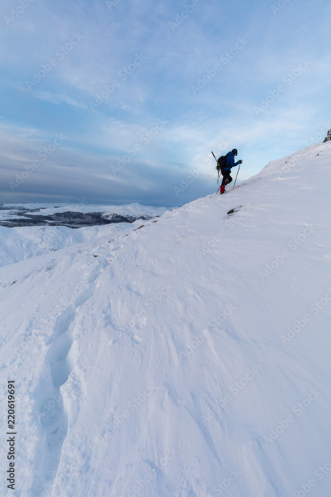 Winter hill walker on the slopes of Ben Ledi, Scotland