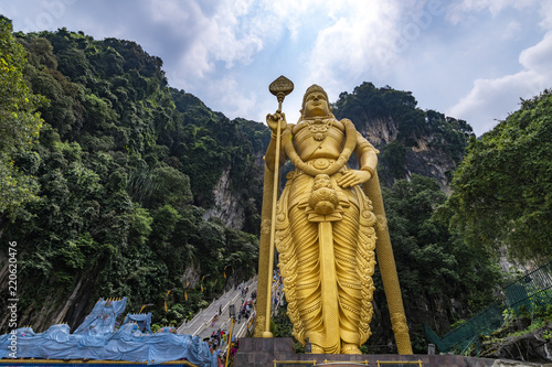 Statue of Lord Muruga outside of the Butu cave, one of the spiritual and famous place and focal point of Hindu festival of Thaipusam for Indian community living in Malaysia photo