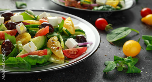 Fresh Greek salad with cucumber, cherry tomato, lettuce, red onion, feta cheese and black olives. Healthy food