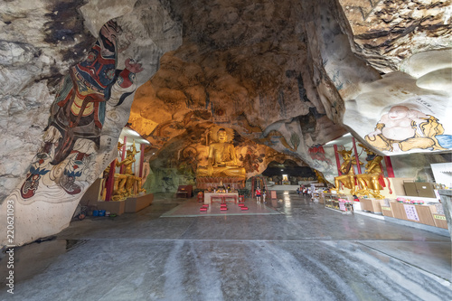 IPOH, 7 August 2018 - Giant golden seated Buddha statue in the middle of the Perak cave temple in Ipoh, Malaysia photo