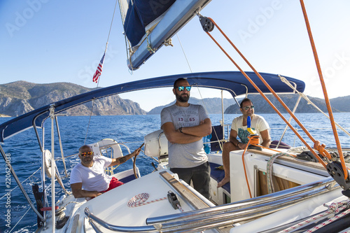 Three men hanging on the boat