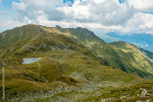 Idyllische Alm Landschaft mit einem Gebirgssee photo