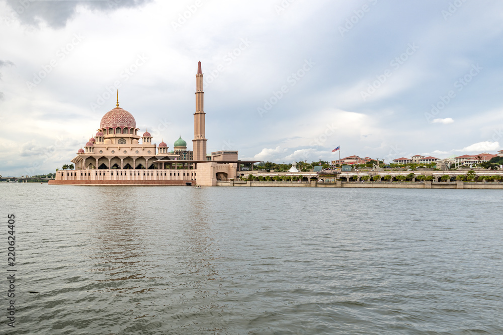 Pink color Putrajaya mosque surrounded by water at Putra Jaya city, the Malaysian Federal Territory administrative city