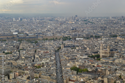 The top view on the city in cloudy, rainy weather. Houses and streets of Paris. France