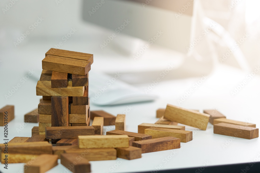 The risk will happen. engineer playing a blocks wood game on wood table vintage tone. architectural project .as background business concept with copy space. The risk will happen. engineer playing a blocks wood game on wood table vintage tone. architectural project .as background business concept with copy space.