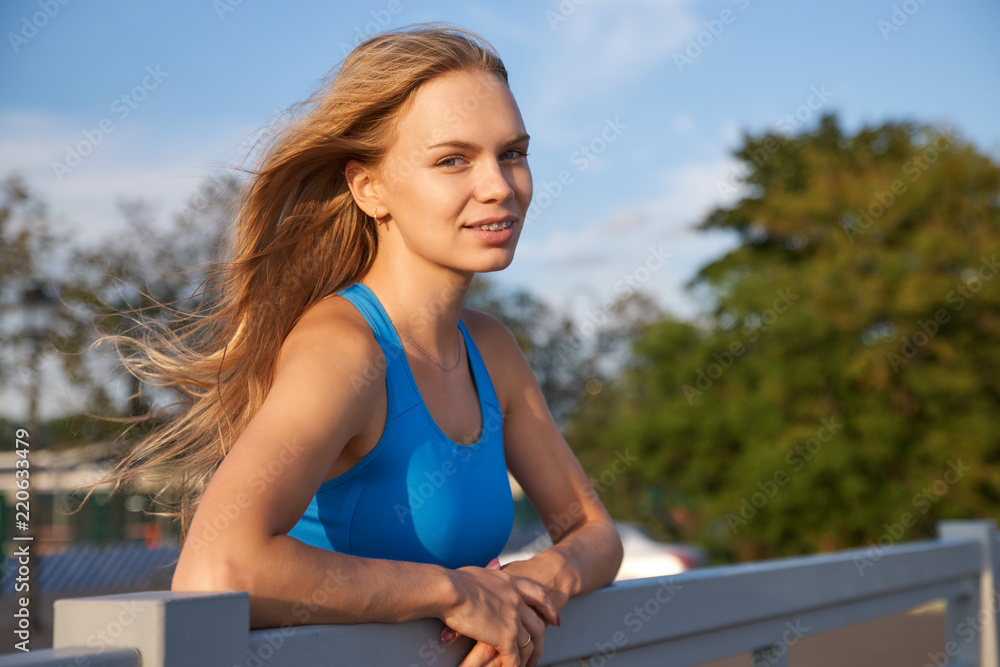 A beautiful woman with fluttering hair from the wind looks at the camera. A beautiful woman with fluttering hair from the wind looks at the camera.
