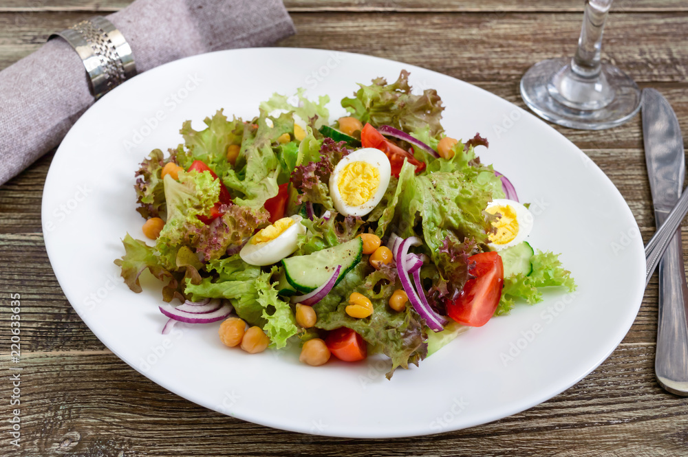 Dietary, vegetarian salad with quail eggs, fresh herbs, chickpeas, red onions and cherry tomatoes. Dietary, vegetarian salad with quail eggs, fresh herbs, chickpeas, red onions and cherry tomatoes.