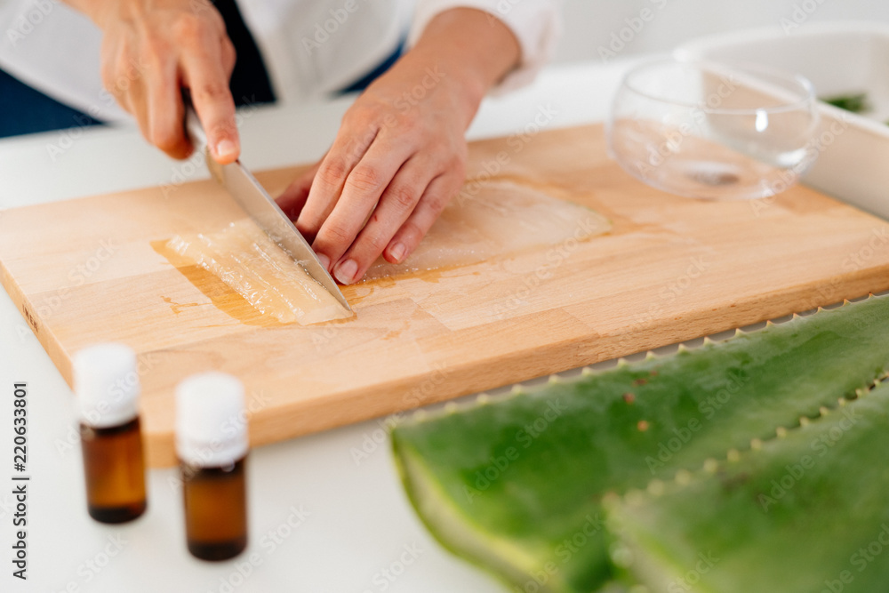 Woman preparing an aloe vera gel recipe with essences. Healthy, natural and cosmetic concept Woman preparing an aloe vera gel recipe with essences. Healthy, natural and cosmetic concept